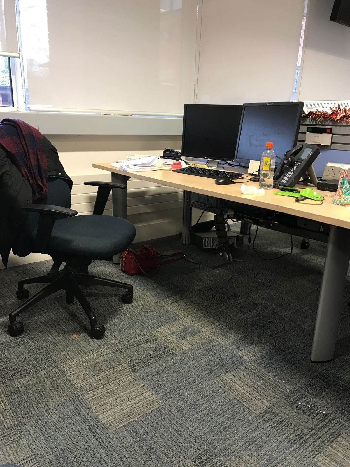 Office before cleaning — cluttered desk with coats and rubbish